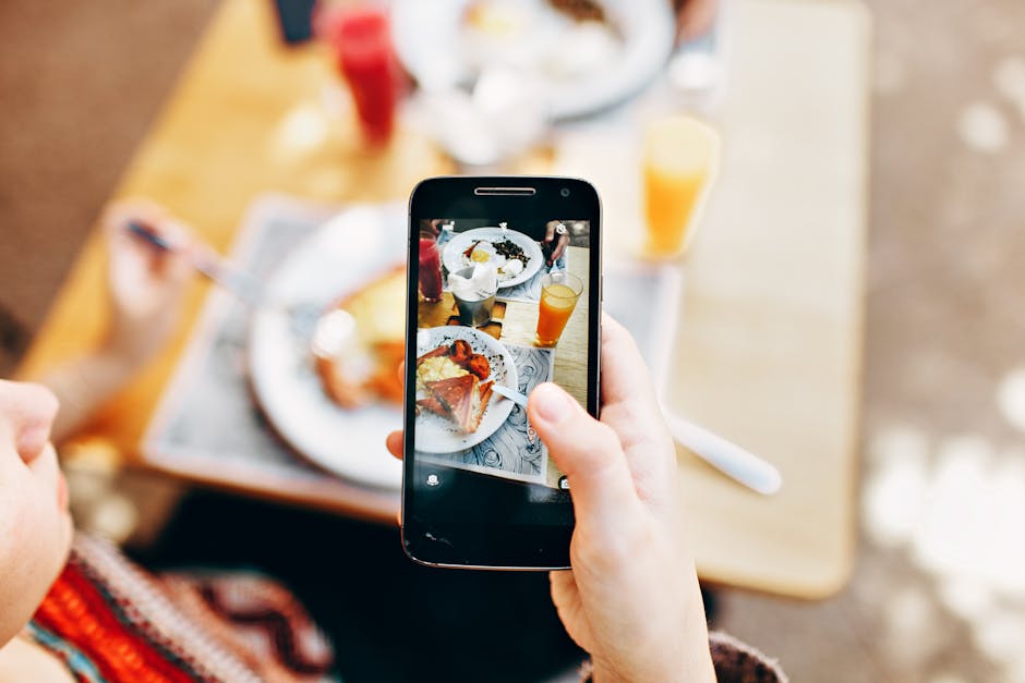 Overhead view of a person photographing a colorful brunch spread